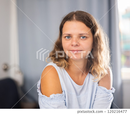 Young positive woman posing in living room Young positive woman posing in living room 120216477