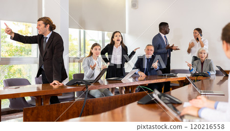 Businesspeople arguing at meeting in office Businesspeople arguing at meeting in office 120216558