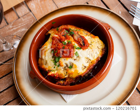 Eggplant and tomatoes served with parmesan Eggplant and tomatoes served with parmesan 120216701