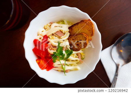 Russian style squid, parsley and tomato salad closeup 120216942