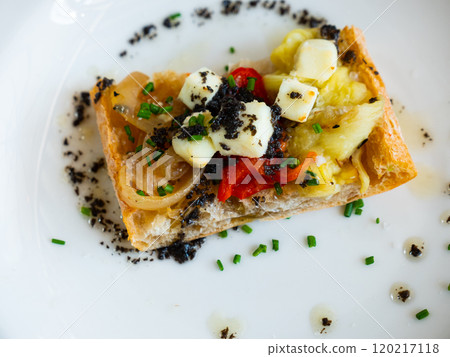 Plate contains sandwich made from of French baguette, stewed Escalibada vegetables, of goat cheese Plate contains sandwich made from of French baguette, stewed Escalibada vegetables, of goat cheese 120217118