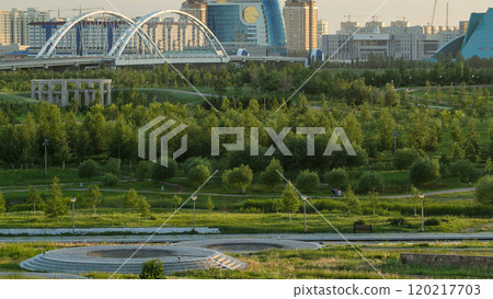 Panorama of the Astana city before sunset timelapse with bridge and buildings. View over the park Panorama of the Astana city before sunset timelapse with bridge and buildings. View over the park 120217703