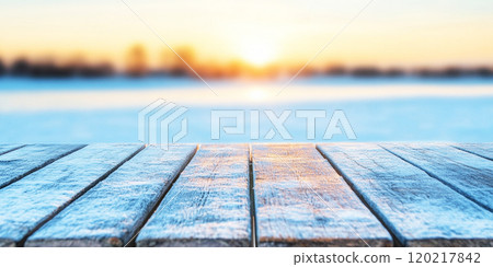 Wood pier or walkway or an old wooden table with blur image of lake and sunset sky in winter background 120217842
