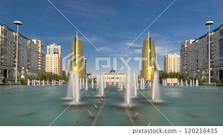 A square in front of Ak Orda with yellow towers timelapse hyperlapse and fountain in the foreground. 120218435