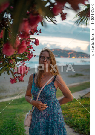 Woman sits on the beach and looks at the sea in Alanya city 120218588