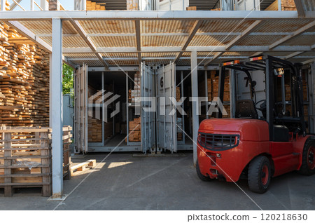 Warehouse forklift and stacked lumber in storage Warehouse forklift and stacked lumber in storage 120218630