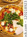 Classic italian pizza with stracciatella and arugula, view from above on the table 120218923