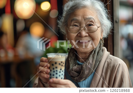Elderly asian woman enjoying a refreshing boba drink in a cafe Elderly asian woman enjoying a refreshing boba drink in a cafe 120218988