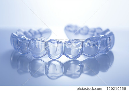 Invisible aligner reflecting on a blue surface, modern orthodontics Invisible aligner reflecting on a blue surface, modern orthodontics 120219266