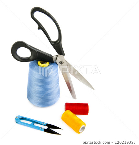 Scissors and and sewing threads isolated on a white. There is free space for text. 120219355