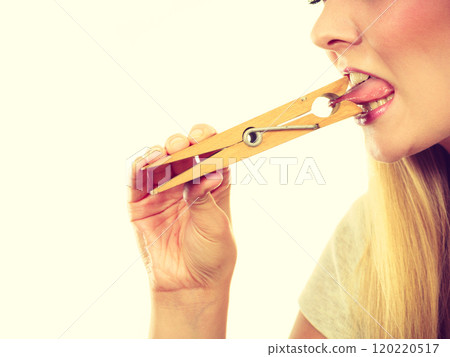 Blonde woman having tongue in clothespin 120220517
