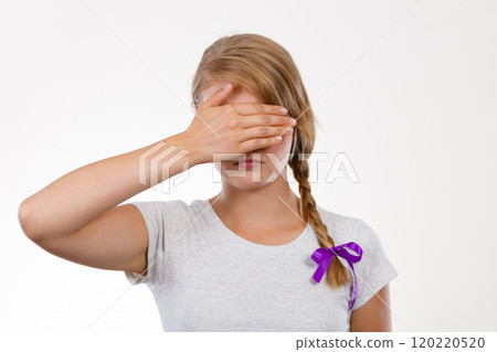 Shy teenage girl hiding face behind hand Shy teenage girl hiding face behind hand 120220520