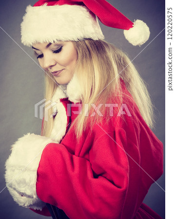 Happy woman wearing Santa Claus helper costume 120220575