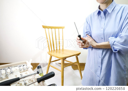 Woman assembling a chair DIY image Woman assembling a chair DIY image 120220858