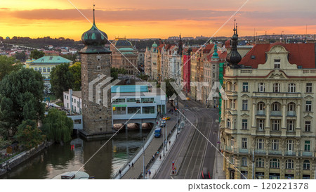 Sitkovska water-tower timelapse and traffic on road in old city center of Prague at sunset time. 120221378