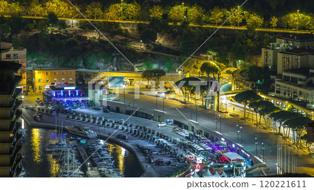 Cityscape of Monte Carlo, Monaco night timelapse with yachts and traffic on embankment. 120221611