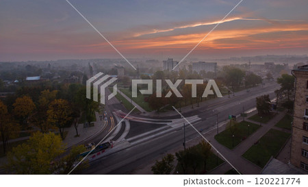 Sunrise over road intersection with reconstructed tram tracks aerial panoramic timelapse. Sunrise over road intersection with reconstructed tram tracks aerial panoramic timelapse. 120221774