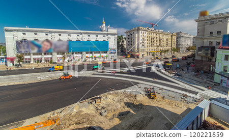 Workers operating asphalt paver machines during road construction and repairing works timelapse 120221859