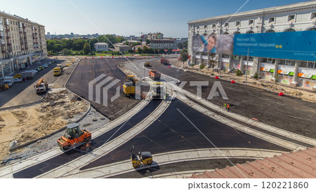 Workers operating asphalt paver machines during road construction and repairing works timelapse 120221860