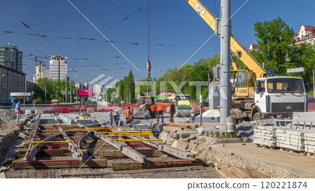 Loader crane for loading and unloading concrete plates on a road construction site timelapse 120221874