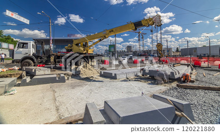 Installing concrete plates by crane at road construction site timelapse. Installing concrete plates by crane at road construction site timelapse. 120221880