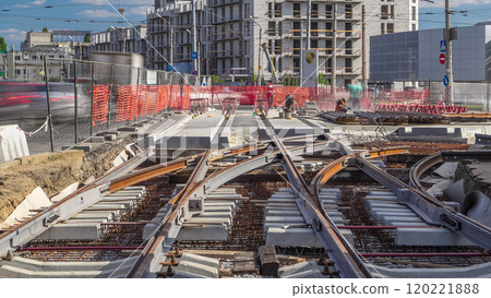 Repair works on the street timelapse. Laying of new tram rails on a city street. 120221888