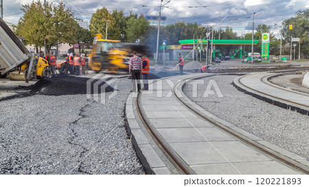 Asphalt roller and excavator on the road repair site during asphalting timelapse. Road construction equipment. Asphalt roller and excavator on the road repair site during asphalting timelapse. Road construction equipment. 120221893