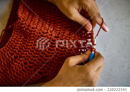 African American Hands Crocheting with Rust Yarn Close-Up African American Hands Crocheting with Rust Yarn Close-Up 120222341