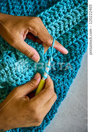 African American Hands Crocheting with Blue Yarn Close-Up Motion African American Hands Crocheting with Blue Yarn Close-Up Motion 120222405