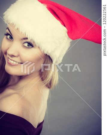Happy woman wearing Santa Claus helper hat Happy woman wearing Santa Claus helper hat 120222561