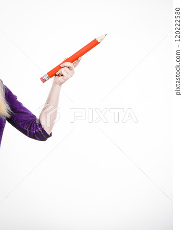 Female hand holds big red pencil Female hand holds big red pencil 120222580