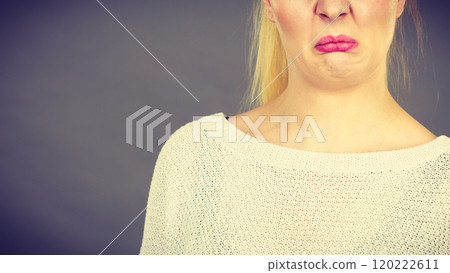Woman having disgusted face expression 120222611