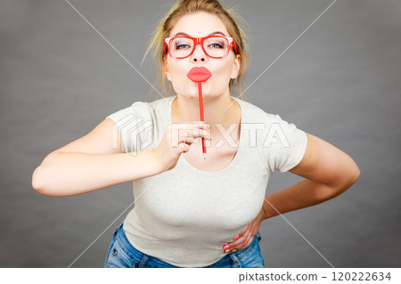 Happy woman holding fake lips on stick Happy woman holding fake lips on stick 120222634