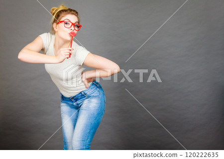 Happy woman holding fake lips on stick Happy woman holding fake lips on stick 120222635