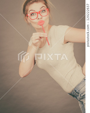Happy woman holding fake lips on stick Happy woman holding fake lips on stick 120222637