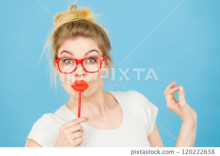 Happy woman holding fake lips on stick Happy woman holding fake lips on stick 120222638