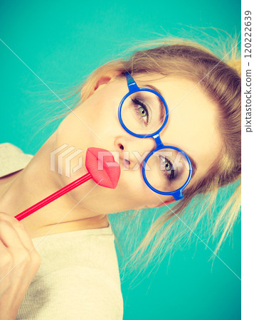 Happy woman holding fake lips on stick Happy woman holding fake lips on stick 120222639