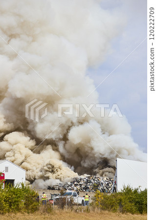 Scrap Yard Fire and Smoke Plume with Workers in Motion, Eye Level Perspective 120222709