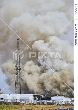 Massive Smoke Plume Over Scrap Metal Fire with Response Vehicles Eye Level View Massive Smoke Plume Over Scrap Metal Fire with Response Vehicles Eye Level View 120222731