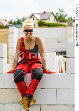 Woman taking break on construction site 120222884