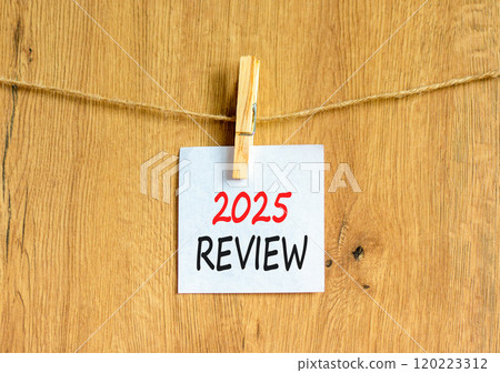 Planning 2025 review new year symbol. Concept words 2025 Review on beautiful white paper on wooden clothespin. Beautiful wooden background. Business 2025 review new year concept. Copy space. Planning 2025 review new year symbol. Concept words 2025 Review on beautiful white paper on wooden clothespin. Beautiful wooden background. Business 2025 review new year concept. Copy space. 120223312
