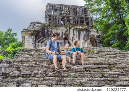 Father with his toddler and teenage sons exploring the ancient pyramids of Palenque, Mexico, surrounded by dense jungle. Cultural heritage and adventure travel concept Father with his toddler and teenage sons exploring the ancient pyramids of Palenque, Mexico, surrounded by dense jungle. Cultural heritage and adventure travel concept 120223777