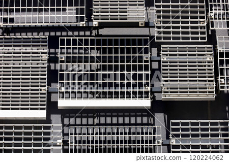 The wall of a modern building with randomly placed metal louvers of various designs and sizes 120224062