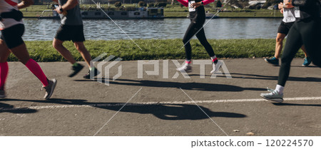 Motion blurred marathon runners in a city. Group of marathon runners compete in the race outdoors 120224570
