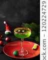 Xmas Grinch Punch in glass decorated sugar rim on black table make of cool lime sherbet. Tasty drink for Christmas holiday. Rim your festive beverages in red sugar. 120224729