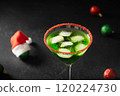Xmas Grinch Punch in glass decorated sugar rim on black table make of cool lime sherbet. Tasty drink for Christmas holiday. Rim your festive beverages in red sugar. Close up. 120224730