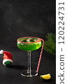 Xmas Grinch Punch in glass decorated sugar rim on black table make of cool lime sherbet. Tasty drink for Christmas holiday. Rim your festive beverages in red sugar. 120224731