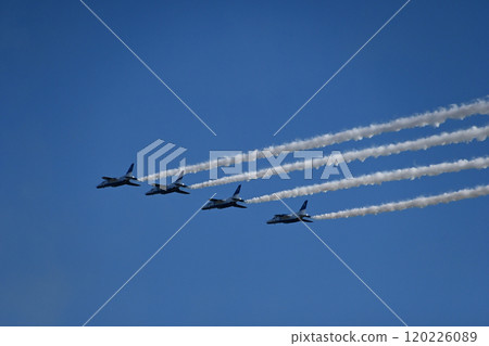 Four Blue Impulse planes flying side by side in the blue sky 120226089