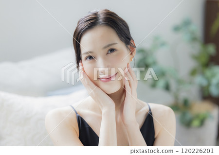 A woman doing skin care in the living room A woman doing skin care in the living room 120226201