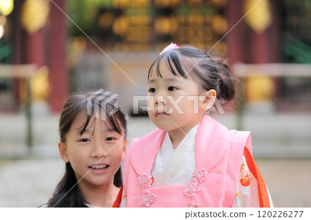 A 3-year-old girl and her 9-year-old sister visiting a shrine for the Shichigosan festival A 3-year-old girl and her 9-year-old sister visiting a shrine for the Shichigosan festival 120226277